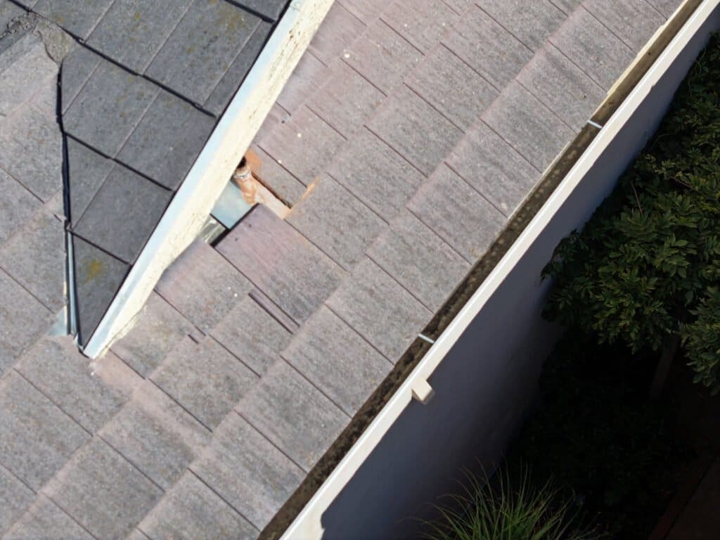 Drone Roof Inspection Roof inspection shows loose tile sliding down that could fall off roof from two stories high.